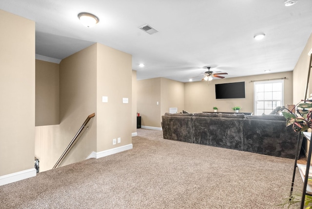 living room with a ceiling fan, carpet, visible vents, and baseboards