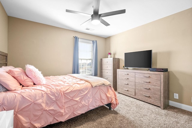 bedroom with baseboards, a ceiling fan, visible vents, and light colored carpet