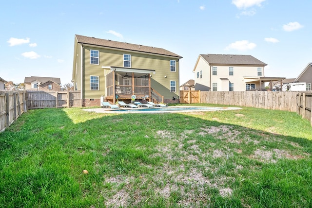 back of property featuring crawl space, a sunroom, a fenced backyard, and a fenced in pool