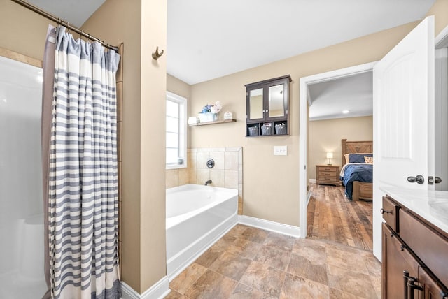 bathroom with a garden tub, connected bathroom, vanity, baseboards, and a shower with curtain