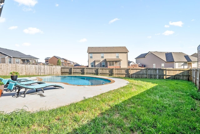 view of swimming pool featuring a fenced in pool, a yard, a patio area, a residential view, and a fenced backyard