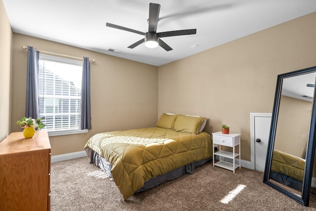 carpeted bedroom with a ceiling fan, visible vents, and baseboards