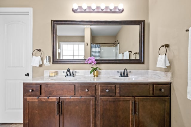 bathroom with a sink and double vanity