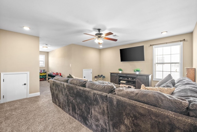 living room featuring carpet floors, plenty of natural light, visible vents, and baseboards