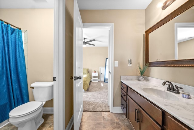 full bathroom featuring curtained shower, baseboards, vanity, and toilet