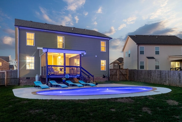 back of property featuring a fenced in pool, a yard, a patio, crawl space, and a fenced backyard