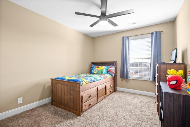 bedroom featuring baseboards, a ceiling fan, visible vents, and light colored carpet