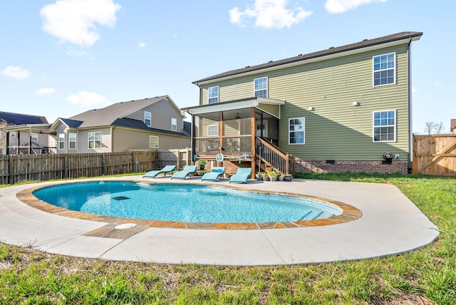 view of swimming pool featuring a patio, a fenced backyard, a sunroom, and a fenced in pool