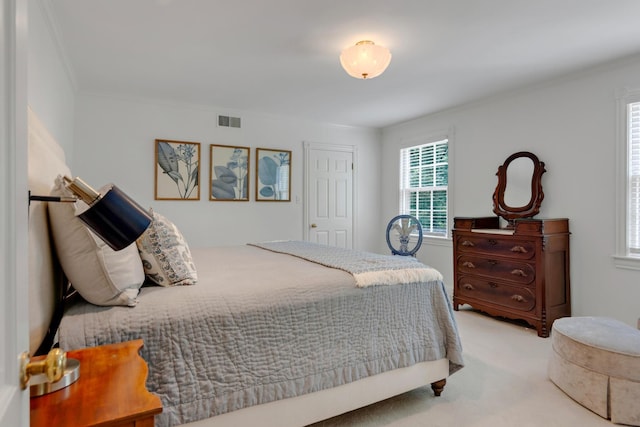 bedroom featuring ornamental molding, carpet, and visible vents