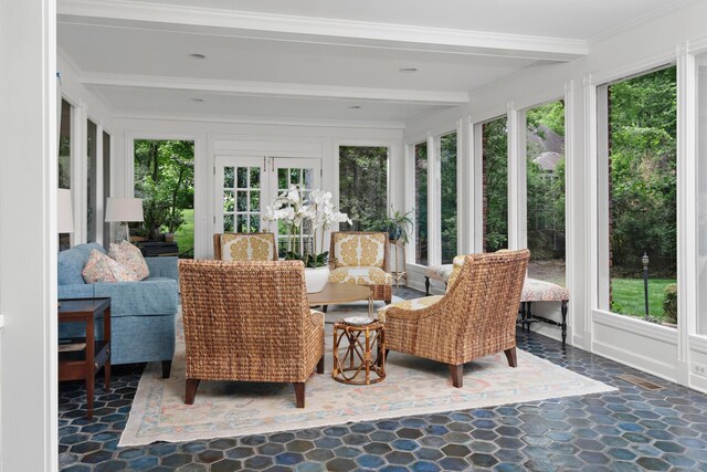 sunroom featuring beamed ceiling