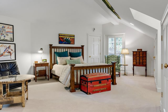 carpeted bedroom featuring lofted ceiling with skylight and baseboards