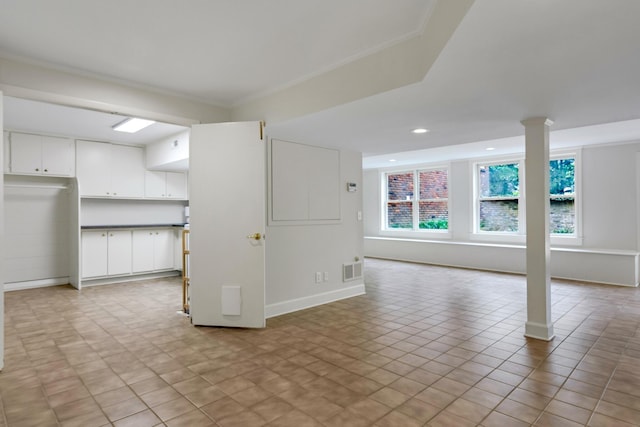 basement with visible vents, ornamental molding, and recessed lighting