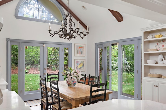 dining space featuring lofted ceiling and a notable chandelier