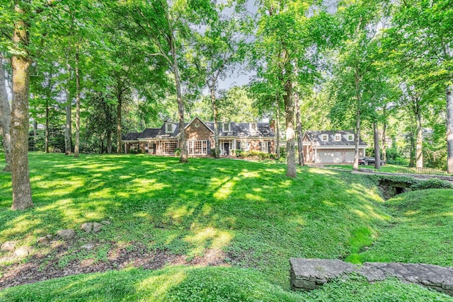 view of front of house with a garage and a front yard