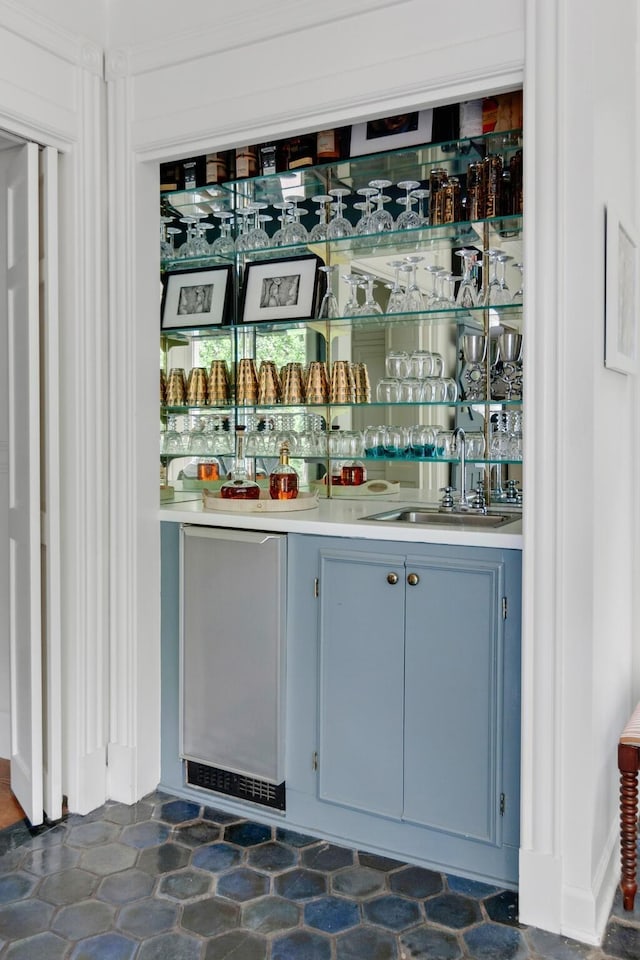 bar featuring indoor wet bar and a sink