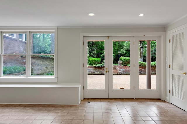 doorway featuring light tile patterned floors, french doors, and a healthy amount of sunlight