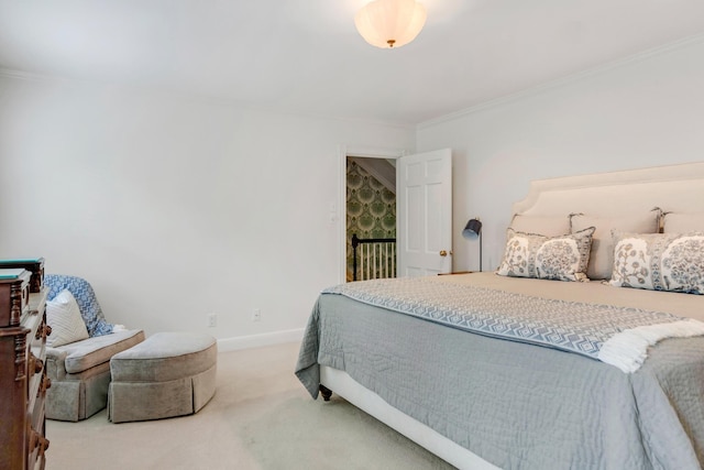 bedroom with ornamental molding, carpet flooring, and baseboards