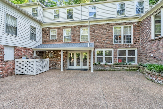 exterior space featuring french doors and brick siding