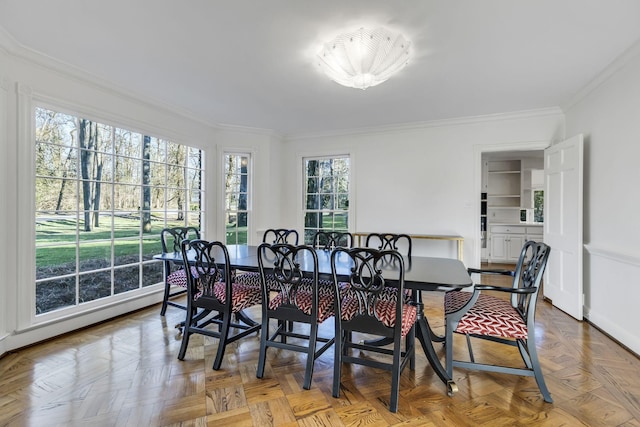 dining area featuring crown molding