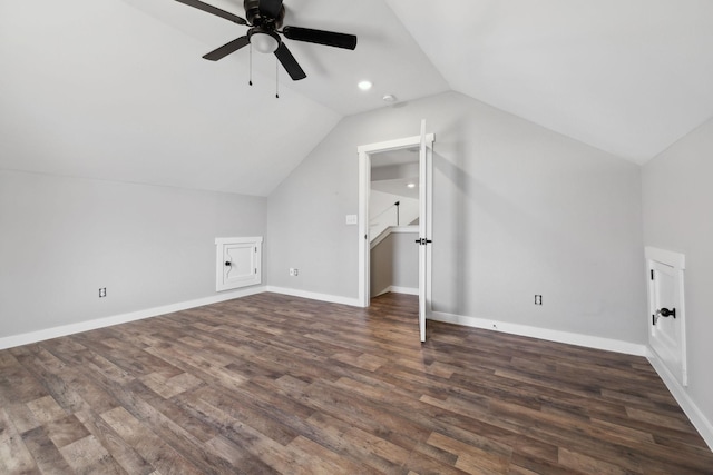 additional living space featuring dark wood-style floors, ceiling fan, baseboards, and vaulted ceiling