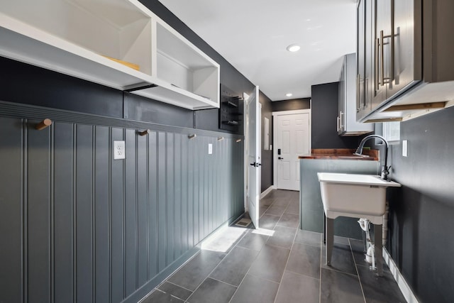 interior space featuring recessed lighting, baseboards, and dark tile patterned flooring