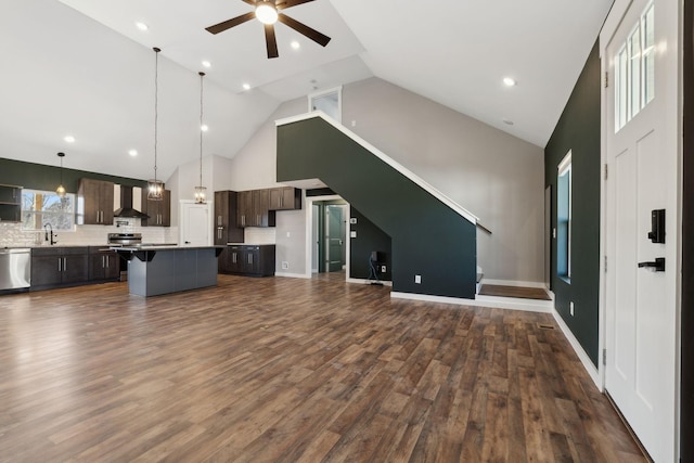 unfurnished living room with baseboards, a ceiling fan, dark wood-style floors, high vaulted ceiling, and a sink