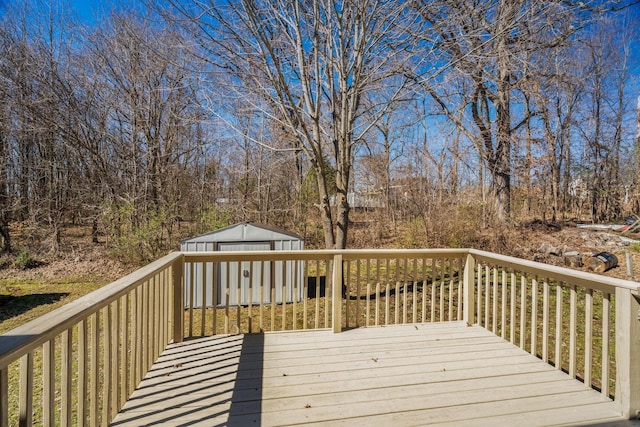 wooden deck featuring a storage unit and an outbuilding