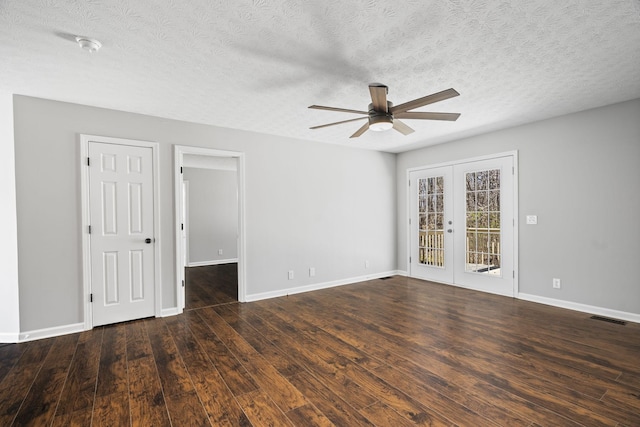 empty room with baseboards, visible vents, wood finished floors, and french doors