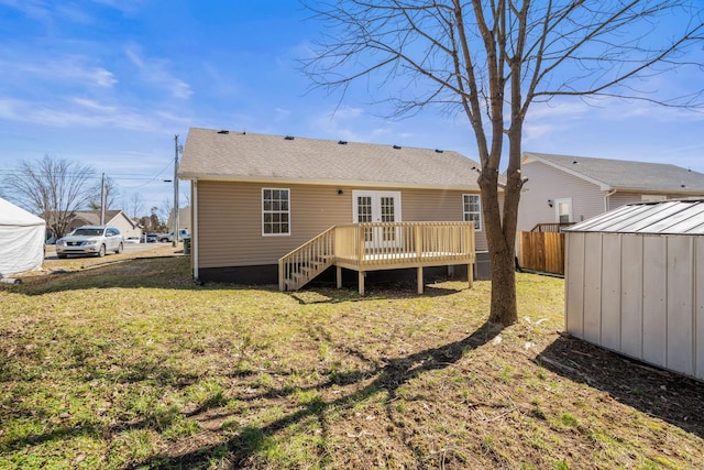 back of property with french doors, a lawn, crawl space, fence, and a wooden deck