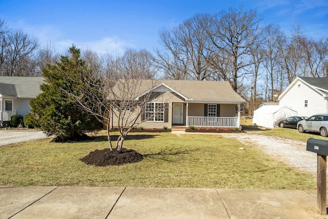 ranch-style home featuring dirt driveway, roof with shingles, a porch, and a front lawn