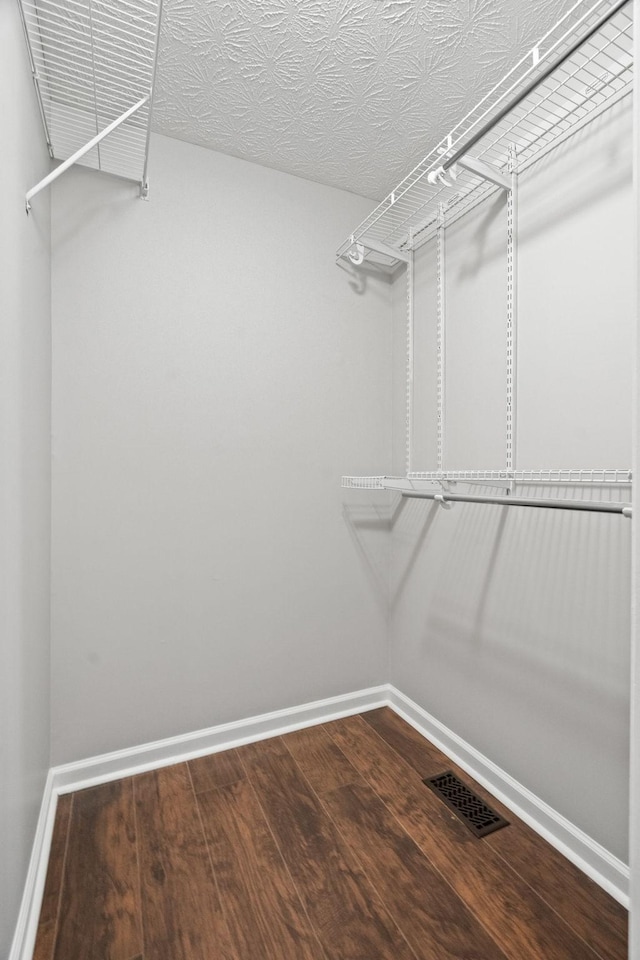 walk in closet featuring visible vents and wood finished floors