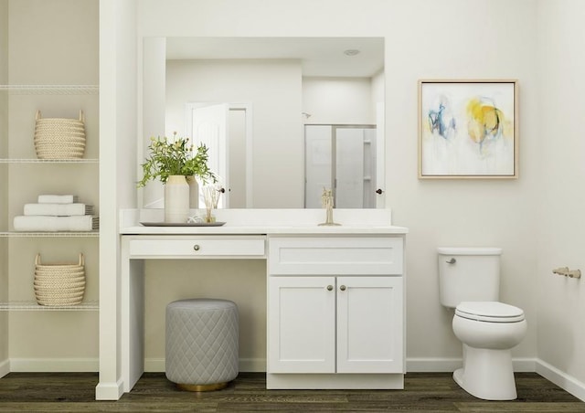 full bath featuring toilet, vanity, a shower stall, wood finished floors, and baseboards