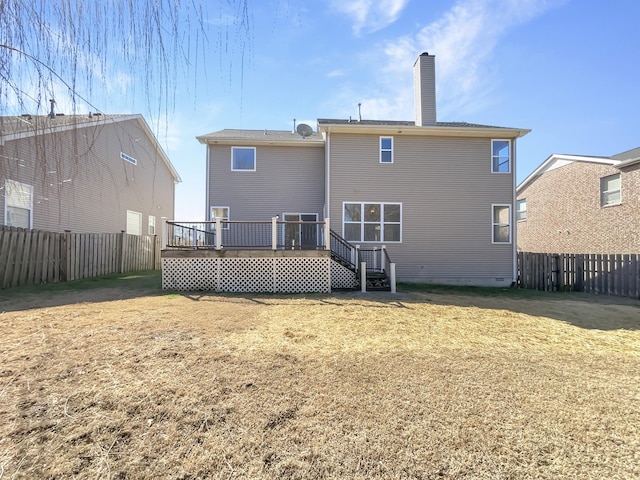 rear view of property featuring crawl space, a fenced backyard, a lawn, and a chimney