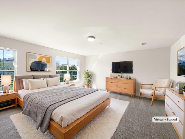 bedroom with visible vents and carpet flooring