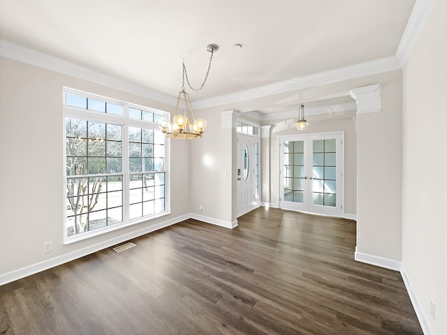 unfurnished dining area featuring dark wood-type flooring, visible vents, baseboards, ornamental molding, and french doors