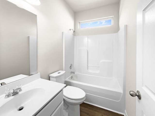 full bath with bathing tub / shower combination, vanity, toilet, and wood finished floors