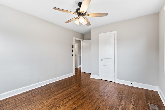 unfurnished room featuring a ceiling fan, baseboards, visible vents, and wood finished floors