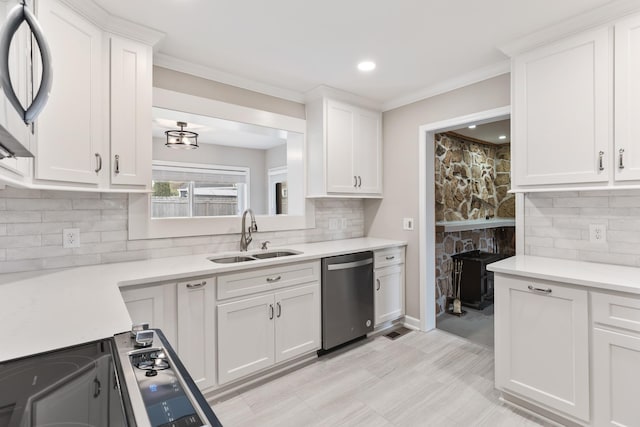 kitchen featuring a sink, white cabinets, light countertops, appliances with stainless steel finishes, and tasteful backsplash