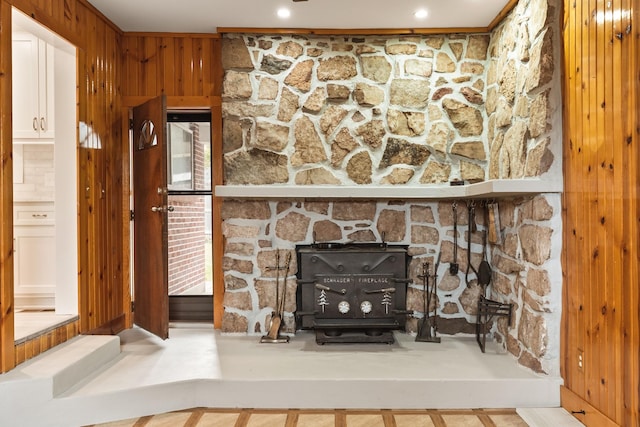 room details featuring a wood stove and wooden walls