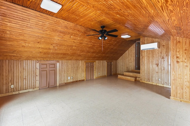 additional living space with a wall unit AC, wood ceiling, wooden walls, and tile patterned floors