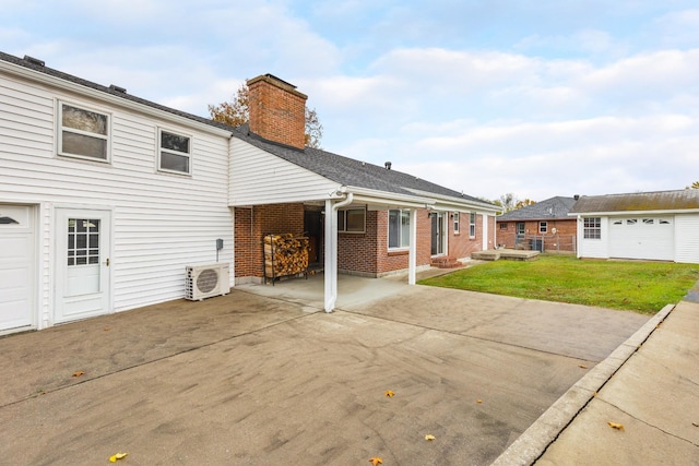 back of property with brick siding, an outdoor structure, a lawn, ac unit, and a chimney