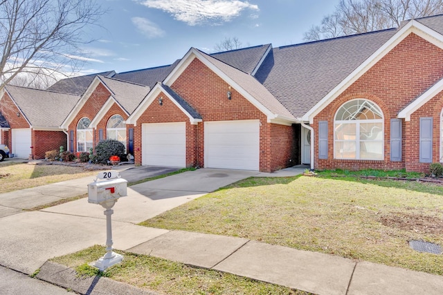 view of front of home with a garage, brick siding, a shingled roof, concrete driveway, and a front yard