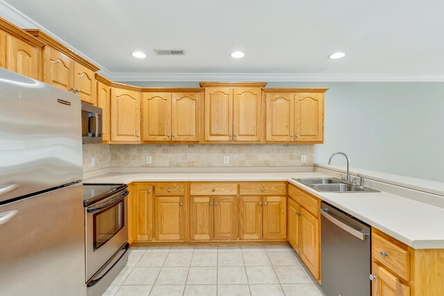 kitchen featuring light tile patterned floors, a sink, visible vents, appliances with stainless steel finishes, and decorative backsplash