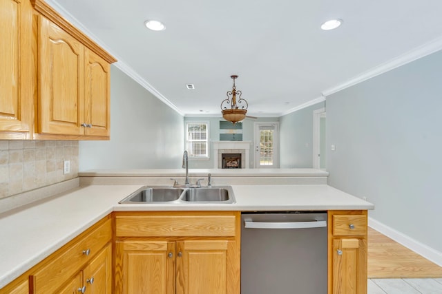 kitchen featuring a peninsula, a sink, ornamental molding, decorative backsplash, and dishwasher