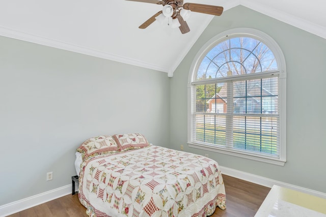 bedroom with dark wood-style flooring, lofted ceiling, ornamental molding, ceiling fan, and baseboards