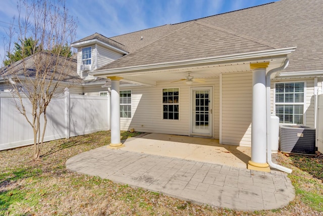 rear view of house with ceiling fan, roof with shingles, fence, cooling unit, and a patio area