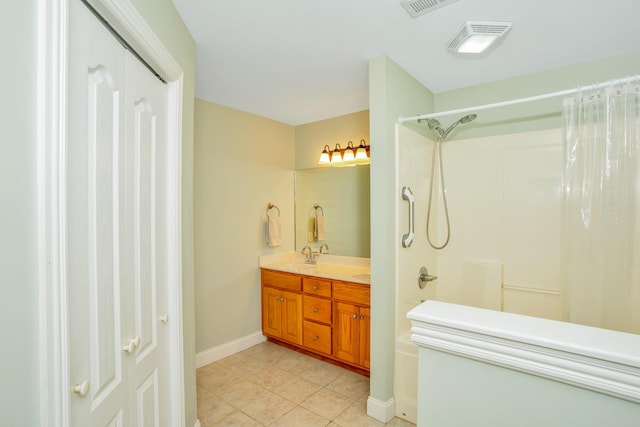 full bathroom with tile patterned flooring, visible vents, baseboards, a shower, and double vanity