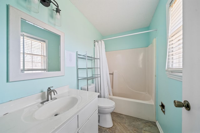 full bath featuring toilet, shower / bath combo with shower curtain, a textured ceiling, and vanity