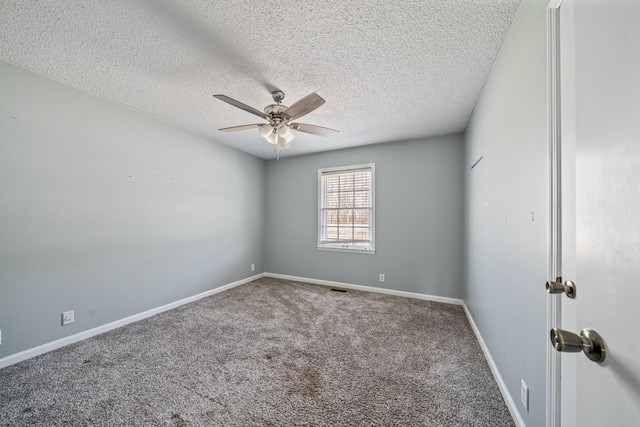 spare room featuring a ceiling fan, carpet flooring, a textured ceiling, and baseboards