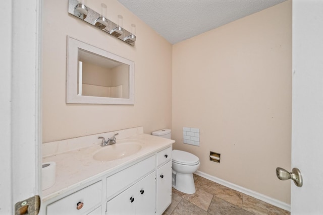 full bath featuring toilet, baseboards, a textured ceiling, and vanity